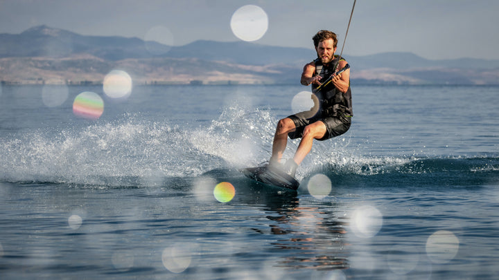 Person wakeboarding and handling rope